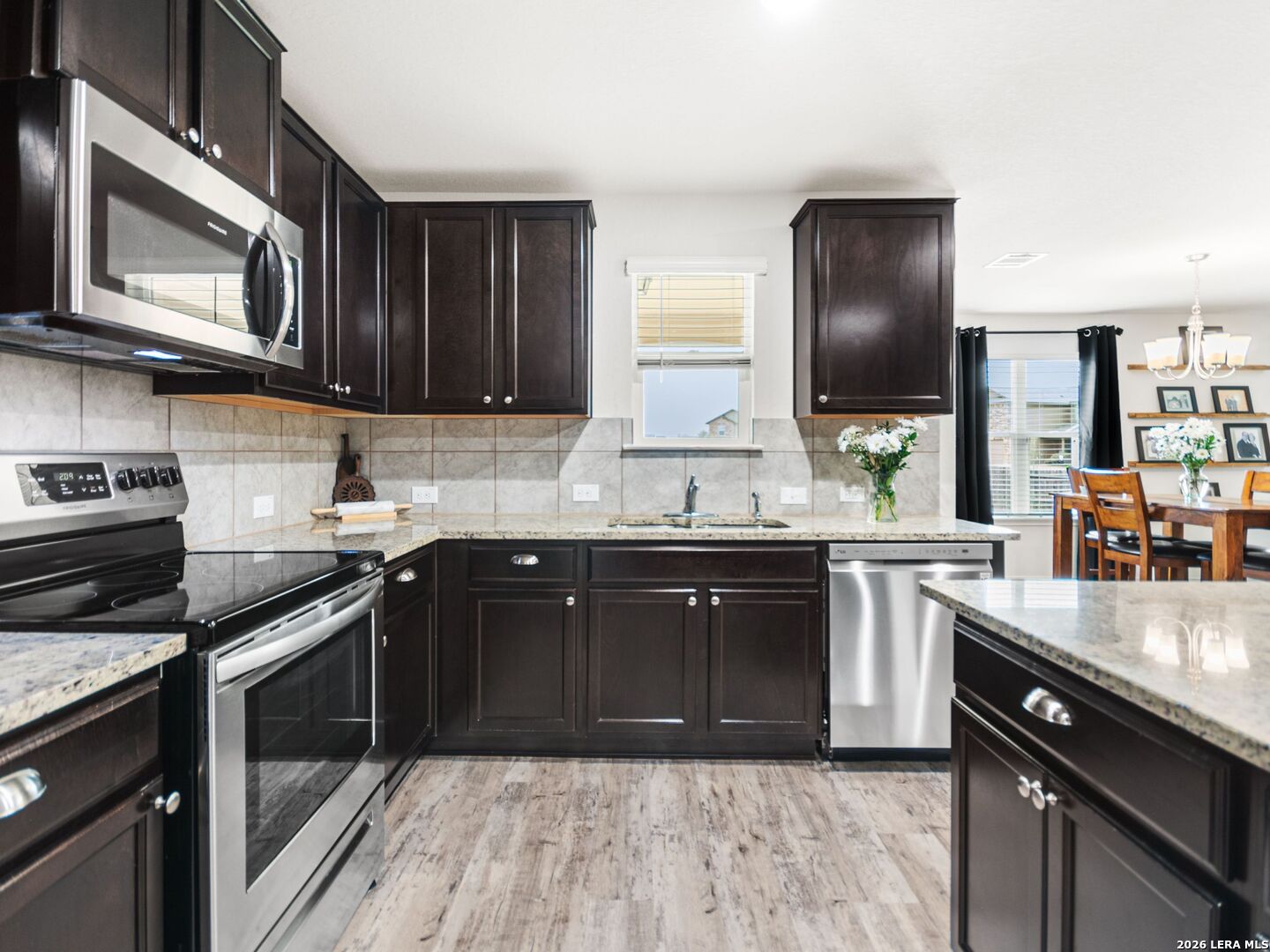 432 Salt Fork Cibolo, TX 78108 - Photo 10 of 19 a kitchen with stainless steel appliances granite countertop a sink stove and microwave