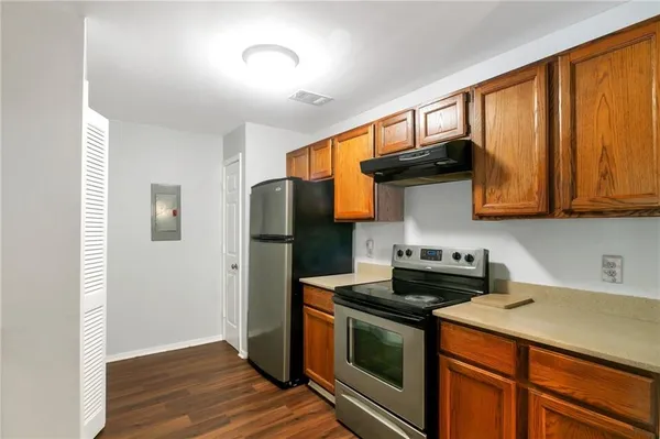 a kitchen with stainless steel appliances granite countertop a stove a refrigerator and a microwave