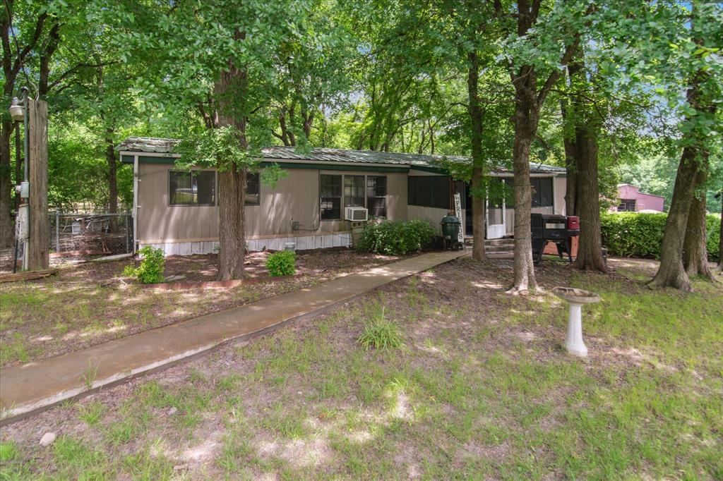 4806 Creekside Road Melissa, TX 75454 - Photo 1 of 10 a view of a patio with table and chairs under an umbrella