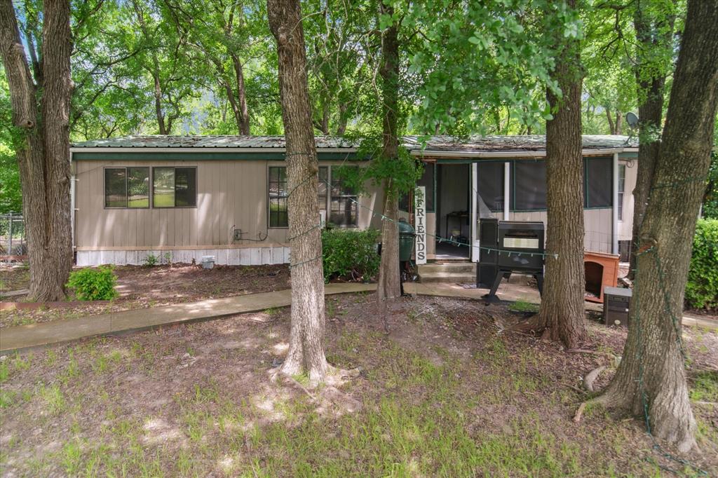4806 Creekside Road Melissa, TX 75454 - Photo 2 of 10 a view of a house with a yard and large tree