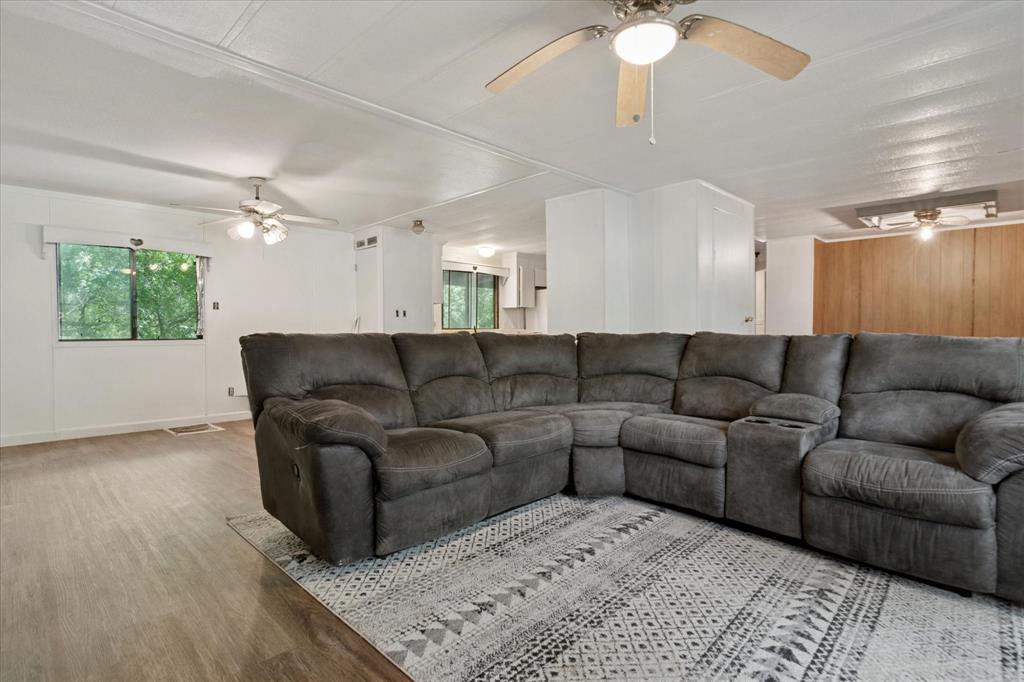 4806 Creekside Road Melissa, TX 75454 - Photo 4 of 10 a living room with furniture and a chandelier