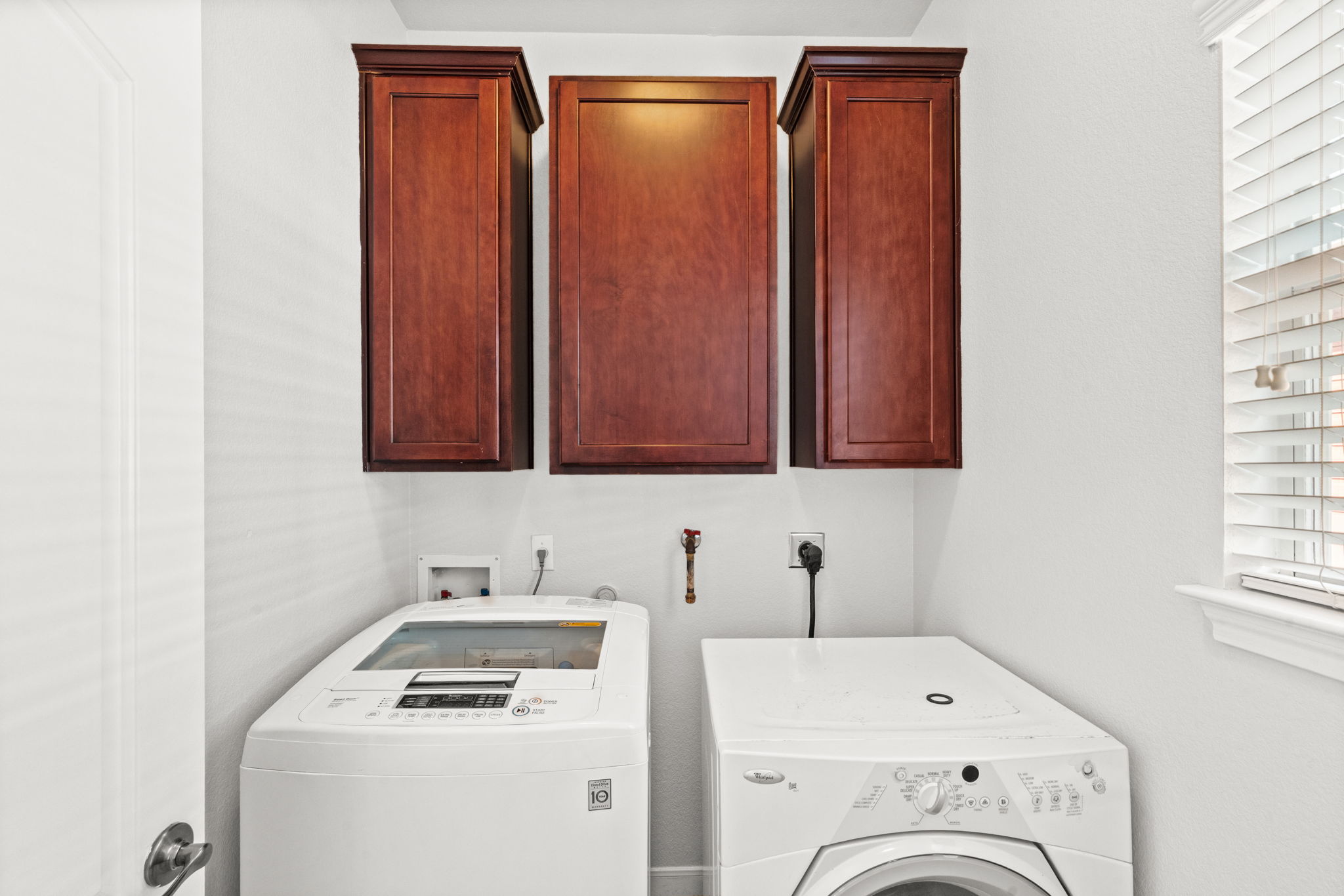 6704 Menchaca Road, Unit 42 Austin, TX 78745 - Photo 10 of 21 Ample cabinetry provides smart storage solutions for this practical laundry space.