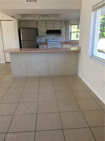 a view of a kitchen with furniture and a window