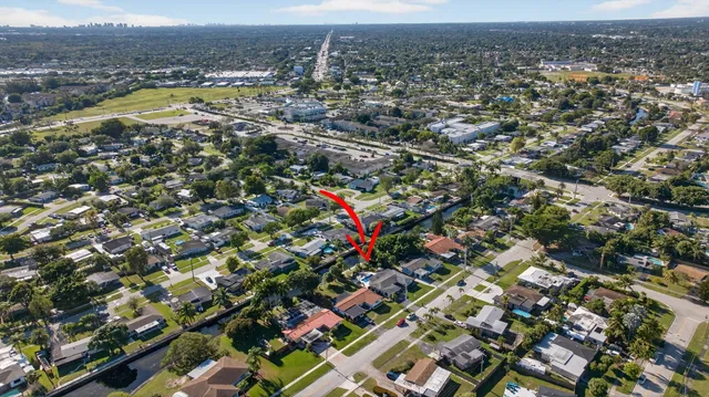 an aerial view of residential houses with outdoor space and swimming pool