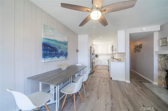 a view of a dining room with furniture wooden floor and a chandelier fan