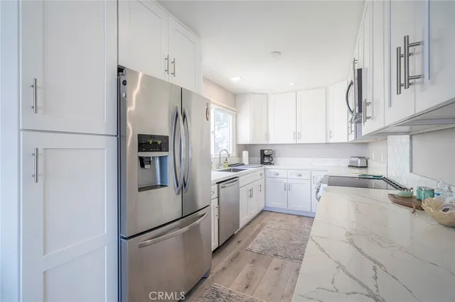 a kitchen with cabinets and stainless steel appliances