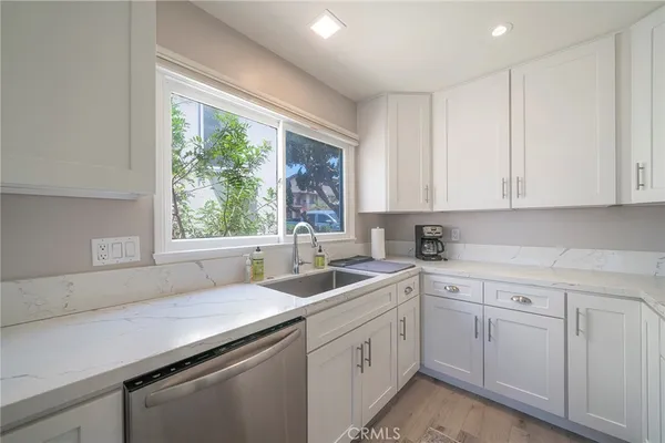 a kitchen with sink cabinets and window