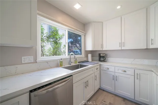 a kitchen with sink cabinets and window