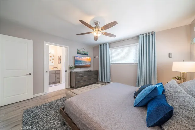 a spacious bedroom with a bed and a chandelier