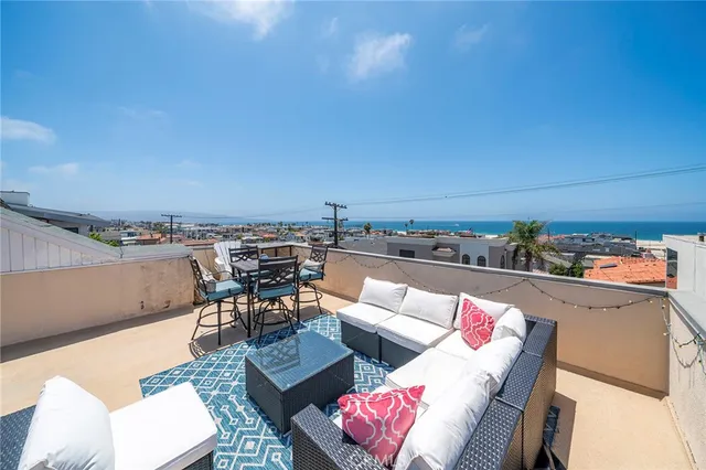 a living room with furniture and a kitchen view