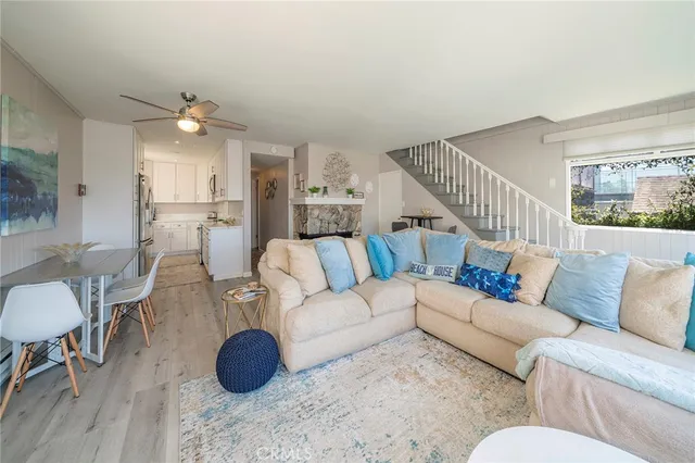 a living room with furniture a dining table and a chandelier