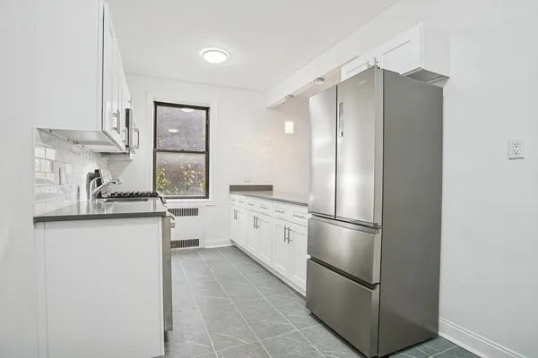 a kitchen with stainless steel appliances a refrigerator sink and cabinets