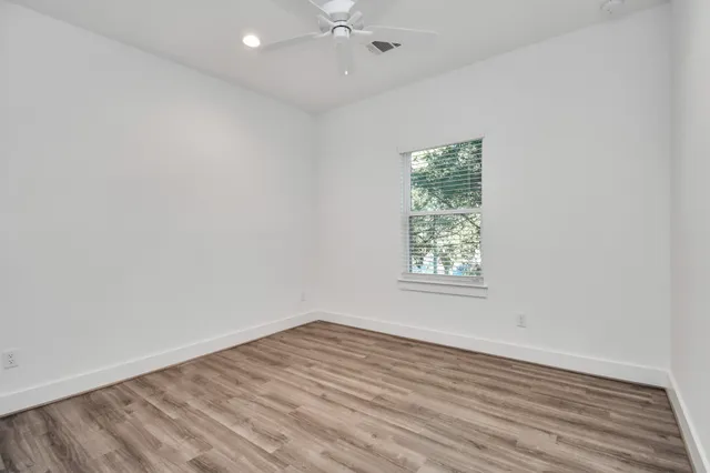 a view of a room with wooden floor