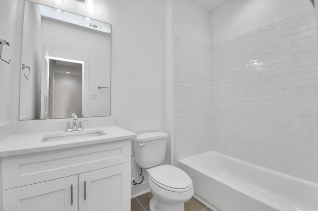 an empty room with a window and wooden floor