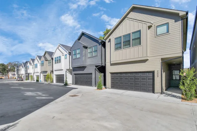 a view of a house with a yard and garage