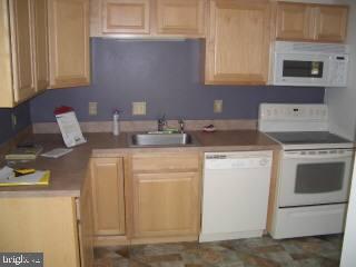 255 Windjammer Road Ocean Pines, MD 21811 - Photo 2 of 4 a kitchen with appliances a sink and cabinets