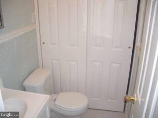 255 Windjammer Road Ocean Pines, MD 21811 - Photo 4 of 4 a white toilet sitting next to a shower