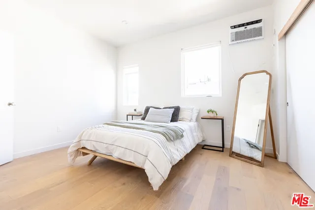 a spacious bedroom with bed and a window