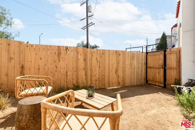 a backyard of a house with table and chairs