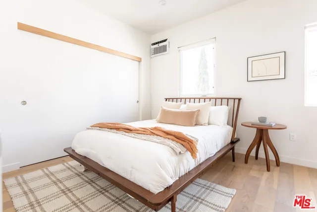 a bedroom with a bed and a table