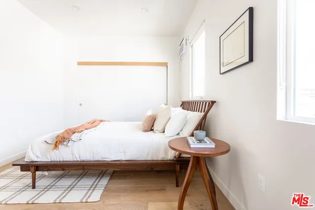 a bedroom with a bed and a lamp on table
