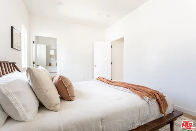 a bedroom with a bed and a night stand