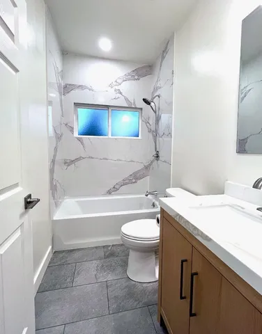a bathroom with a sink a toilet and bathtub