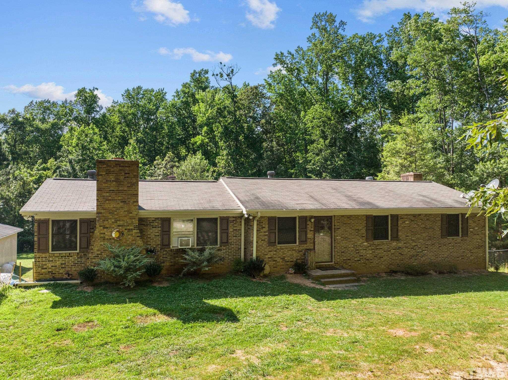 12233 Creedmoor Road Raleigh, NC 27613 - Photo 1 of 57 a front view of a house with a yard