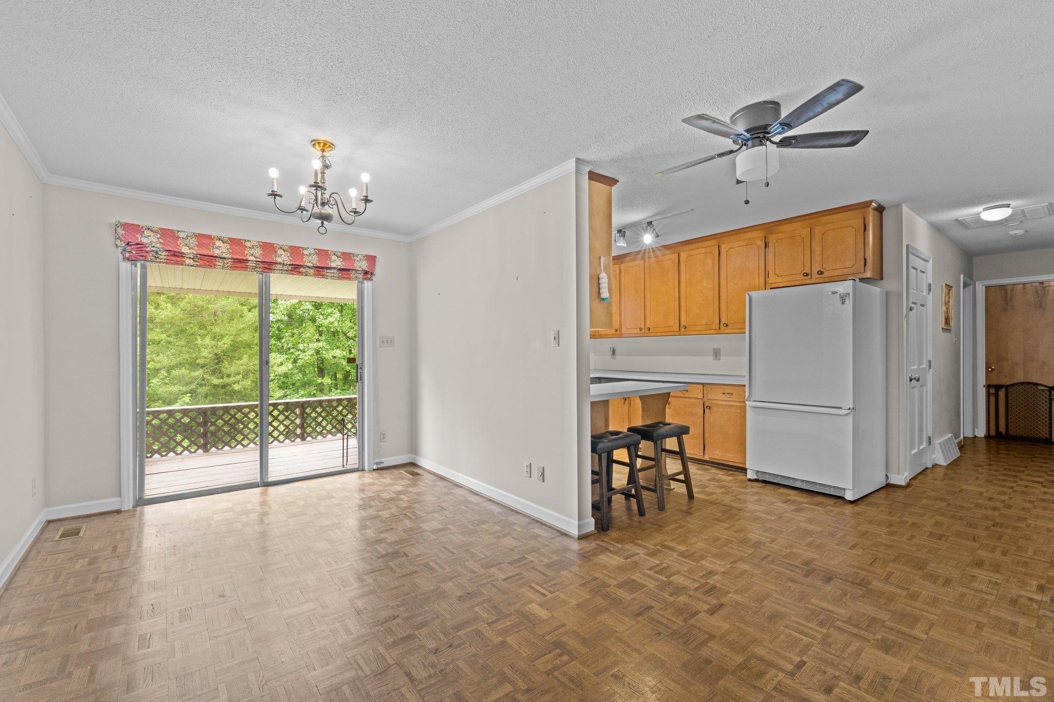 12233 Creedmoor Road Raleigh, NC 27613 - Photo 13 of 57 a view of a livingroom with furniture ceiling fan and window