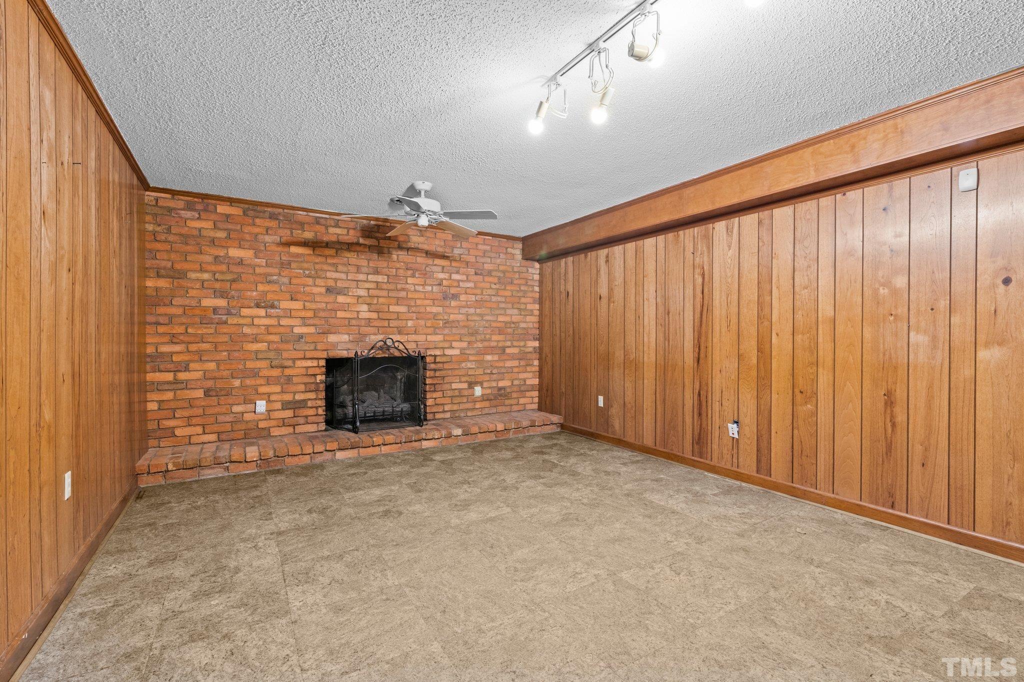 12233 Creedmoor Road Raleigh, NC 27613 - Photo 16 of 57 a view of an empty room with a fireplace