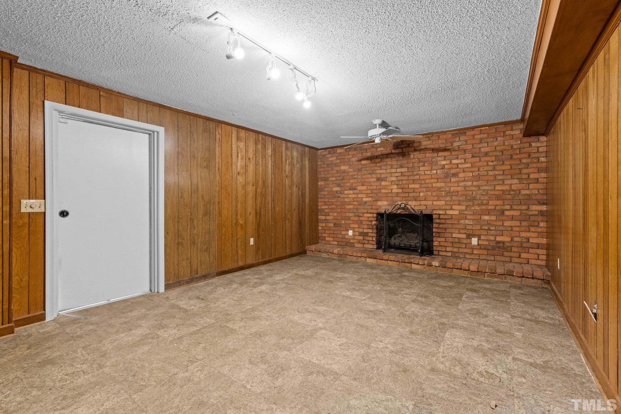 12233 Creedmoor Road Raleigh, NC 27613 - Photo 17 of 57 a view of empty room with a fireplace