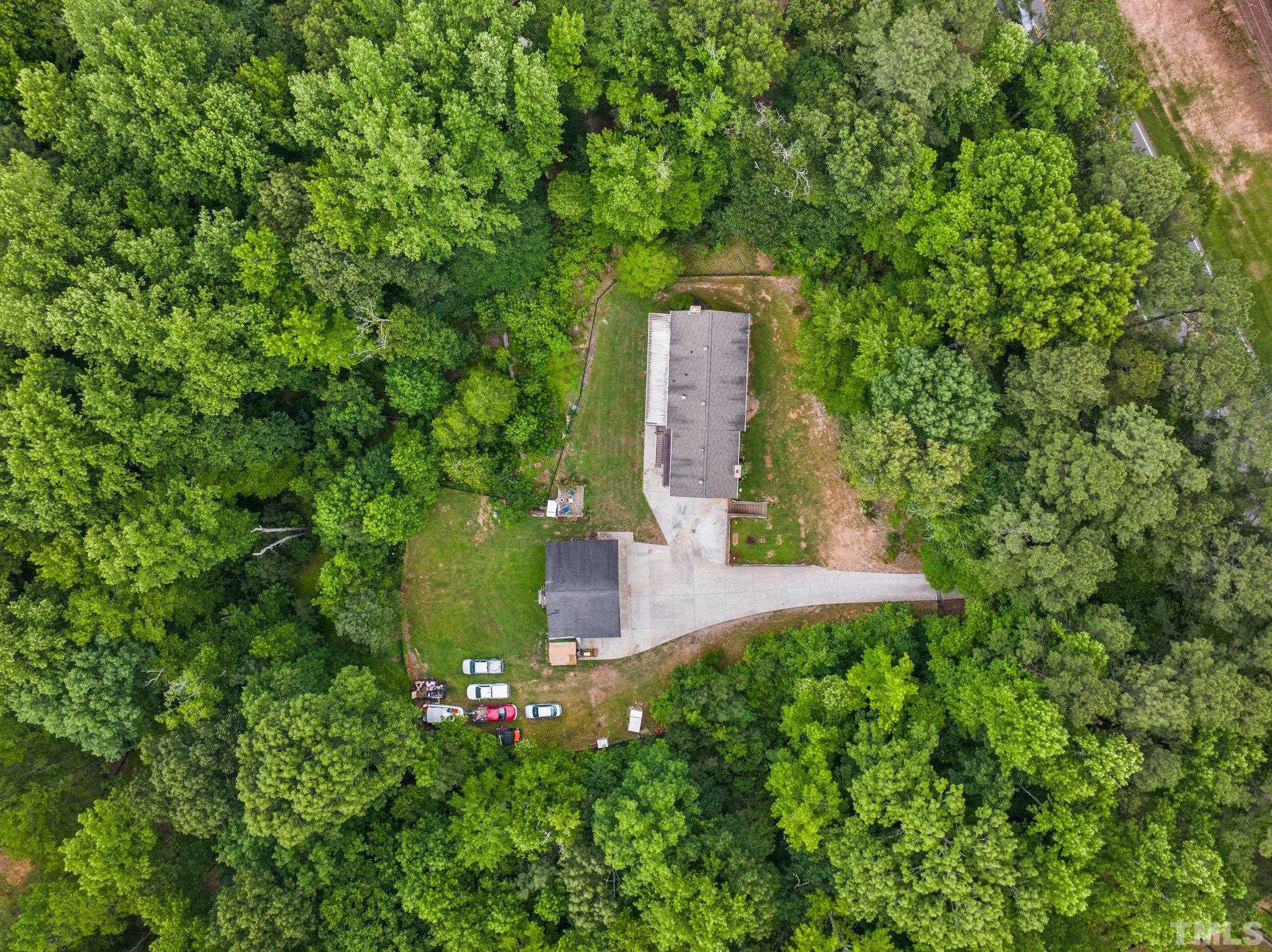 12233 Creedmoor Road Raleigh, NC 27613 - Photo 2 of 57 a view of a tree with a yard