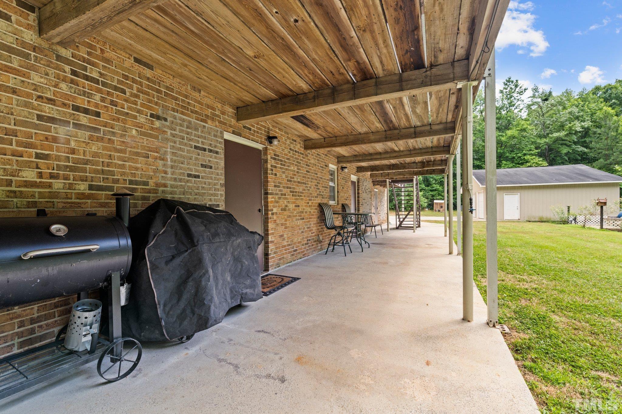 12233 Creedmoor Road Raleigh, NC 27613 - Photo 23 of 57 a view of a porch with furniture