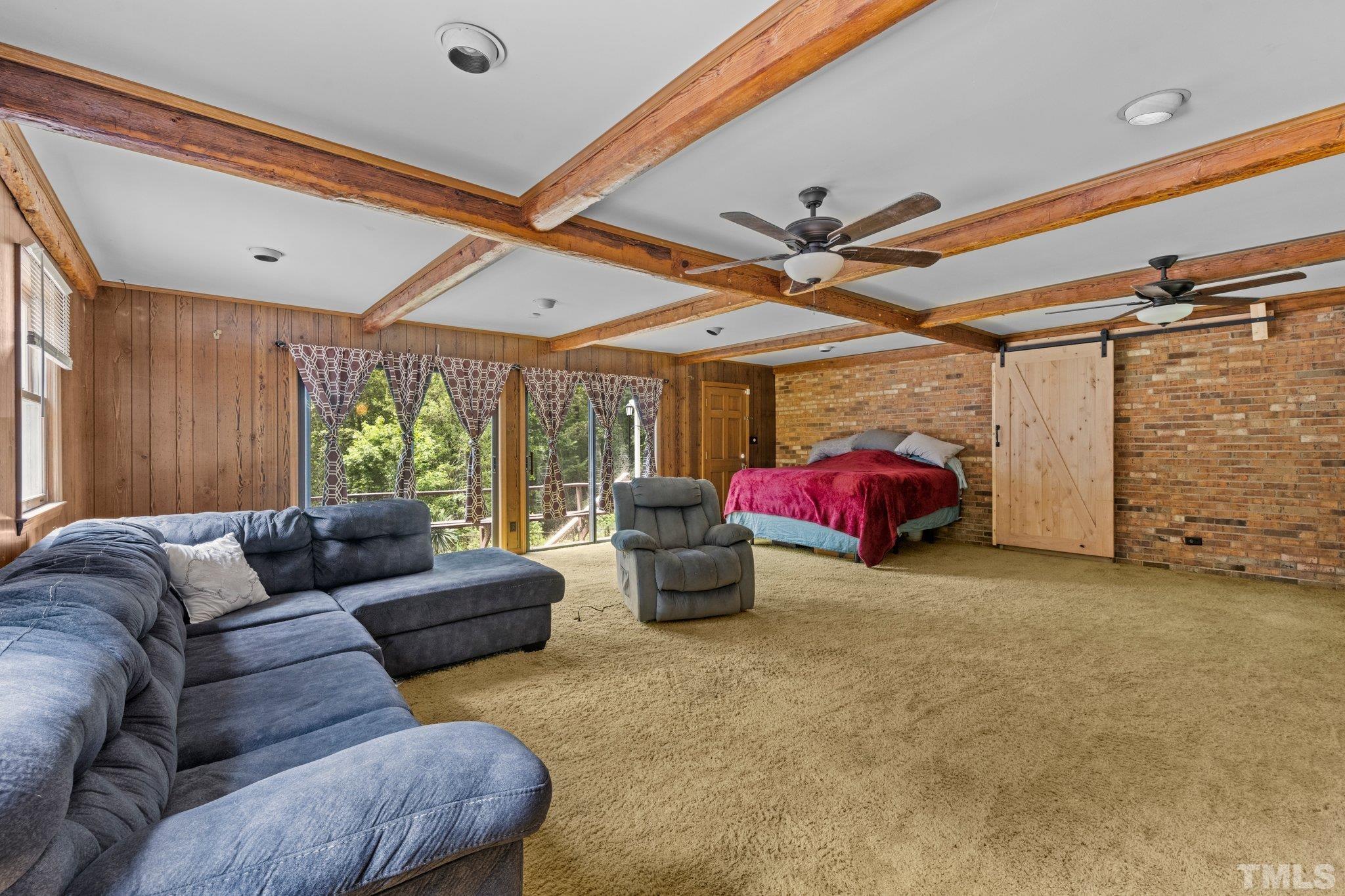 12233 Creedmoor Road Raleigh, NC 27613 - Photo 26 of 57 a living room with furniture a ceiling fan and a window