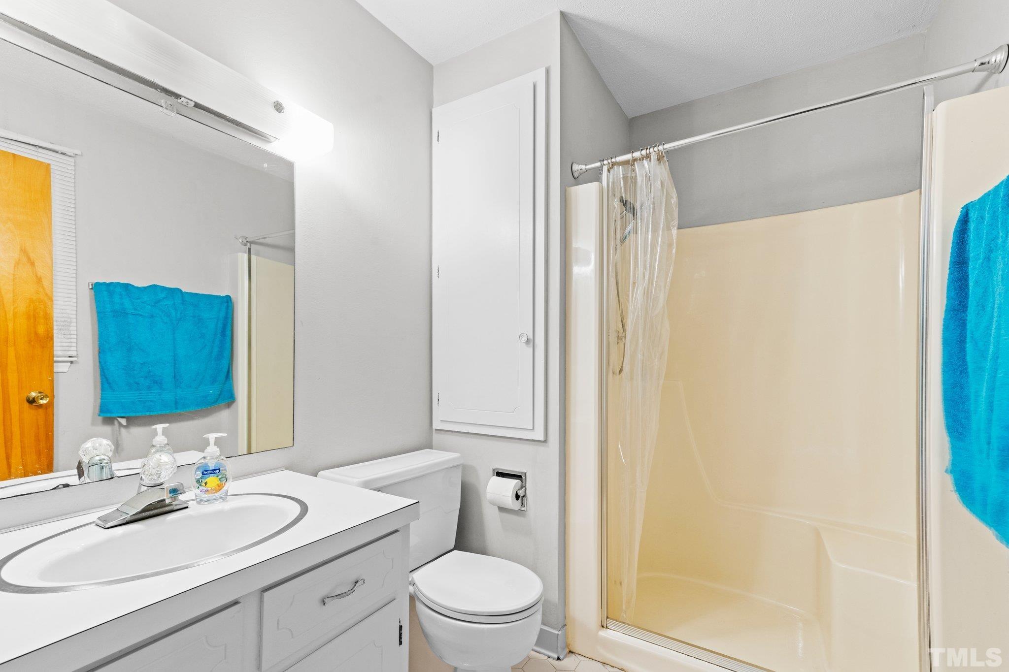 12233 Creedmoor Road Raleigh, NC 27613 - Photo 28 of 57 a bathroom with a granite countertop sink toilet and shower