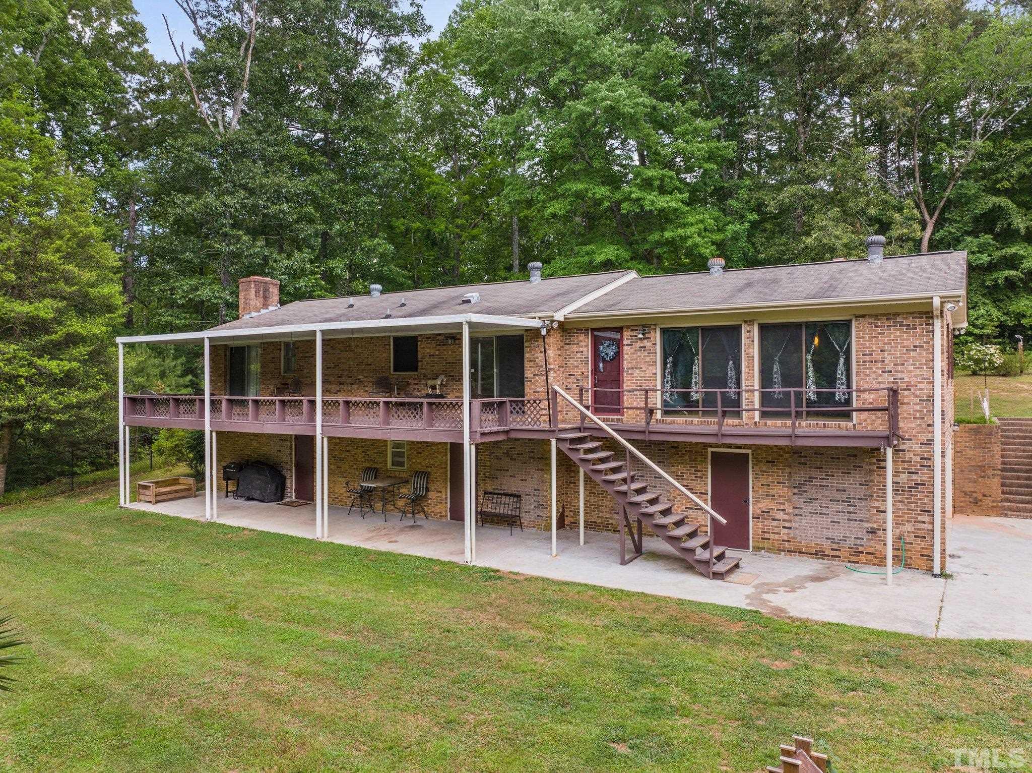 12233 Creedmoor Road Raleigh, NC 27613 - Photo 30 of 57 a view of an house with backyard porch and wooden floor