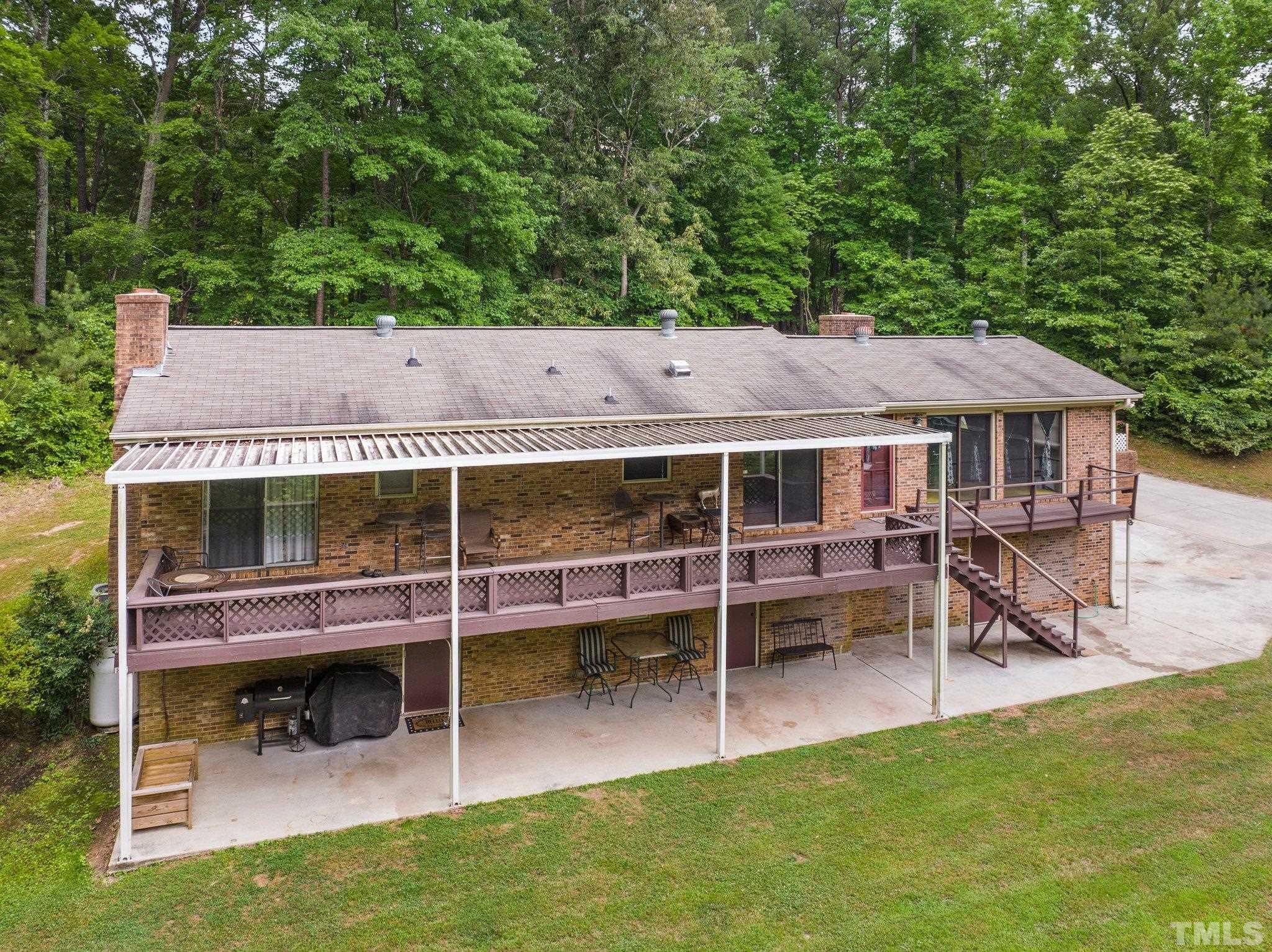 12233 Creedmoor Road Raleigh, NC 27613 - Photo 38 of 57 an aerial view of a house having patio with a garden