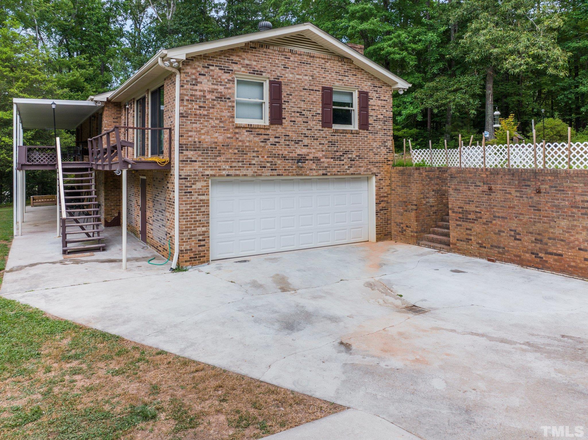 12233 Creedmoor Road Raleigh, NC 27613 - Photo 39 of 57 a front view of a house with a yard and garage