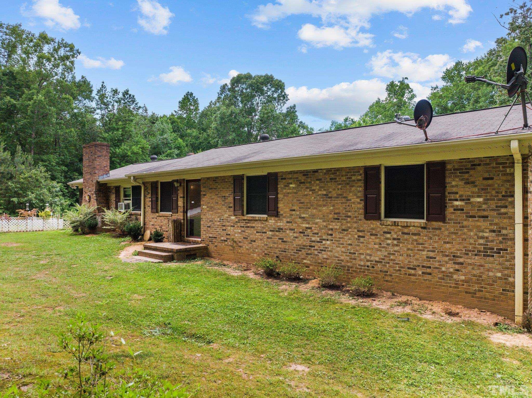 12233 Creedmoor Road Raleigh, NC 27613 - Photo 45 of 57 a front view of house with yard and green space