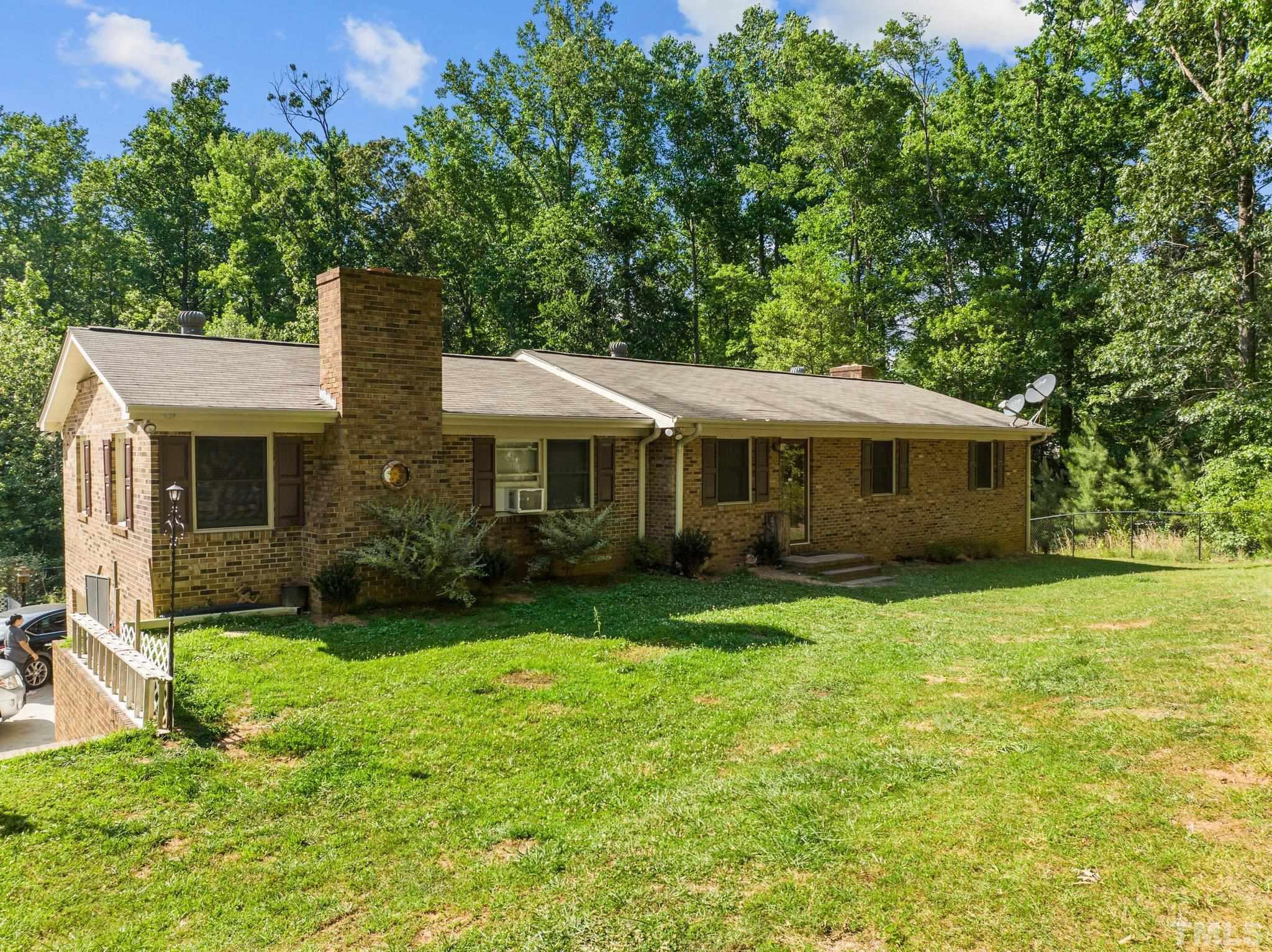12233 Creedmoor Road Raleigh, NC 27613 - Photo 46 of 57 a front view of house with yard and green space
