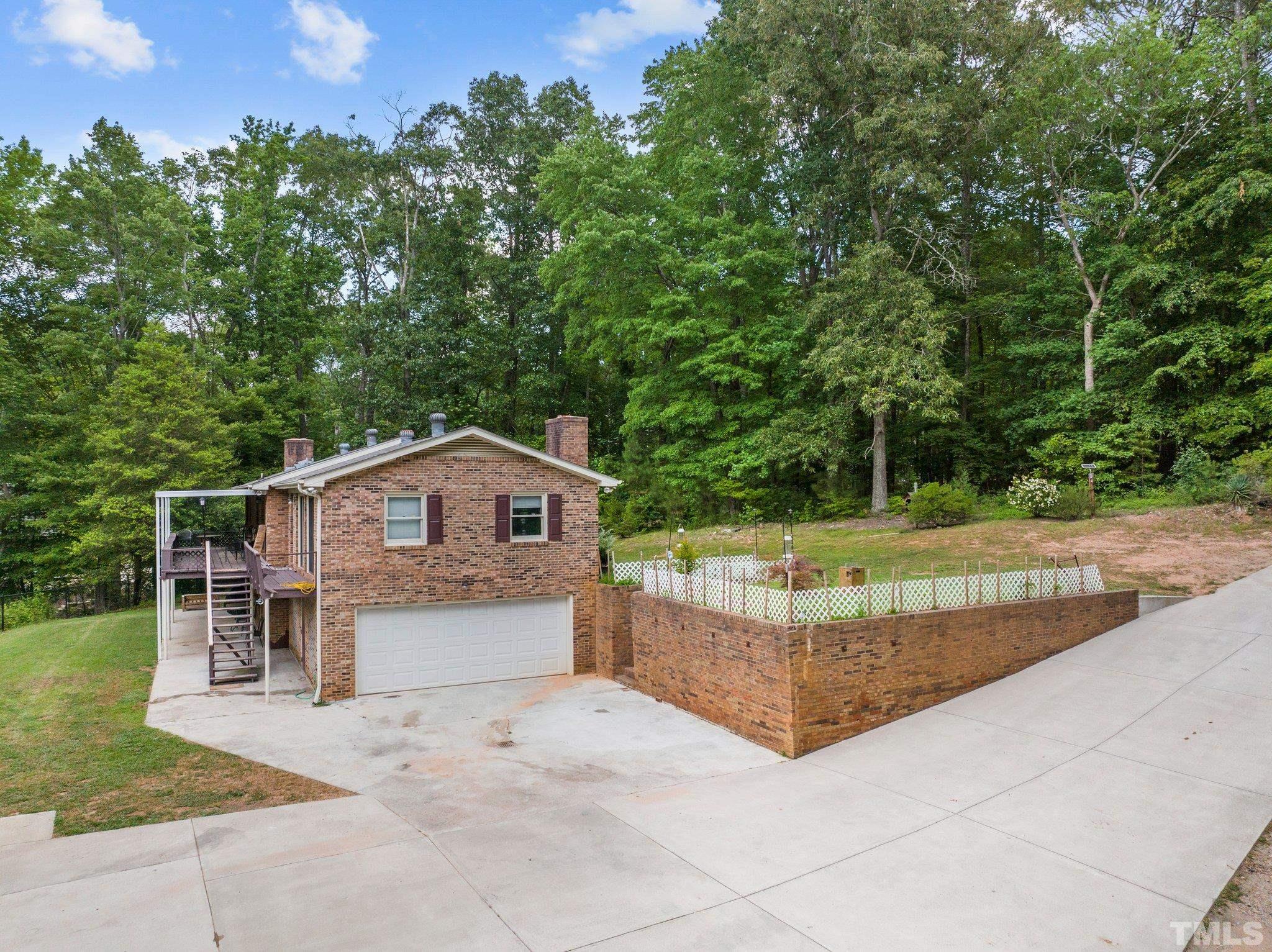 12233 Creedmoor Road Raleigh, NC 27613 - Photo 47 of 57 a view of a house with a yard