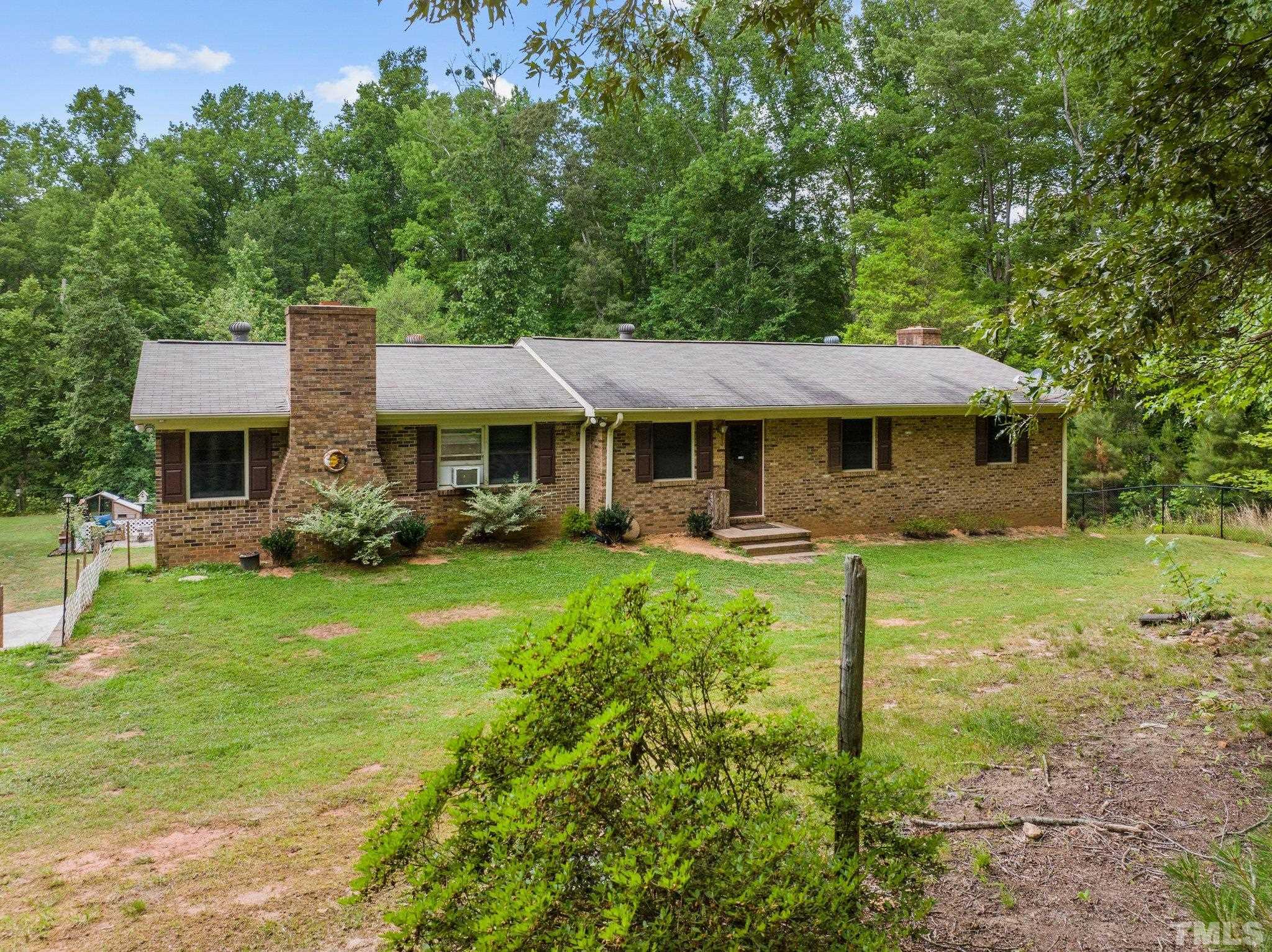 12233 Creedmoor Road Raleigh, NC 27613 - Photo 49 of 57 a front view of a house with a yard