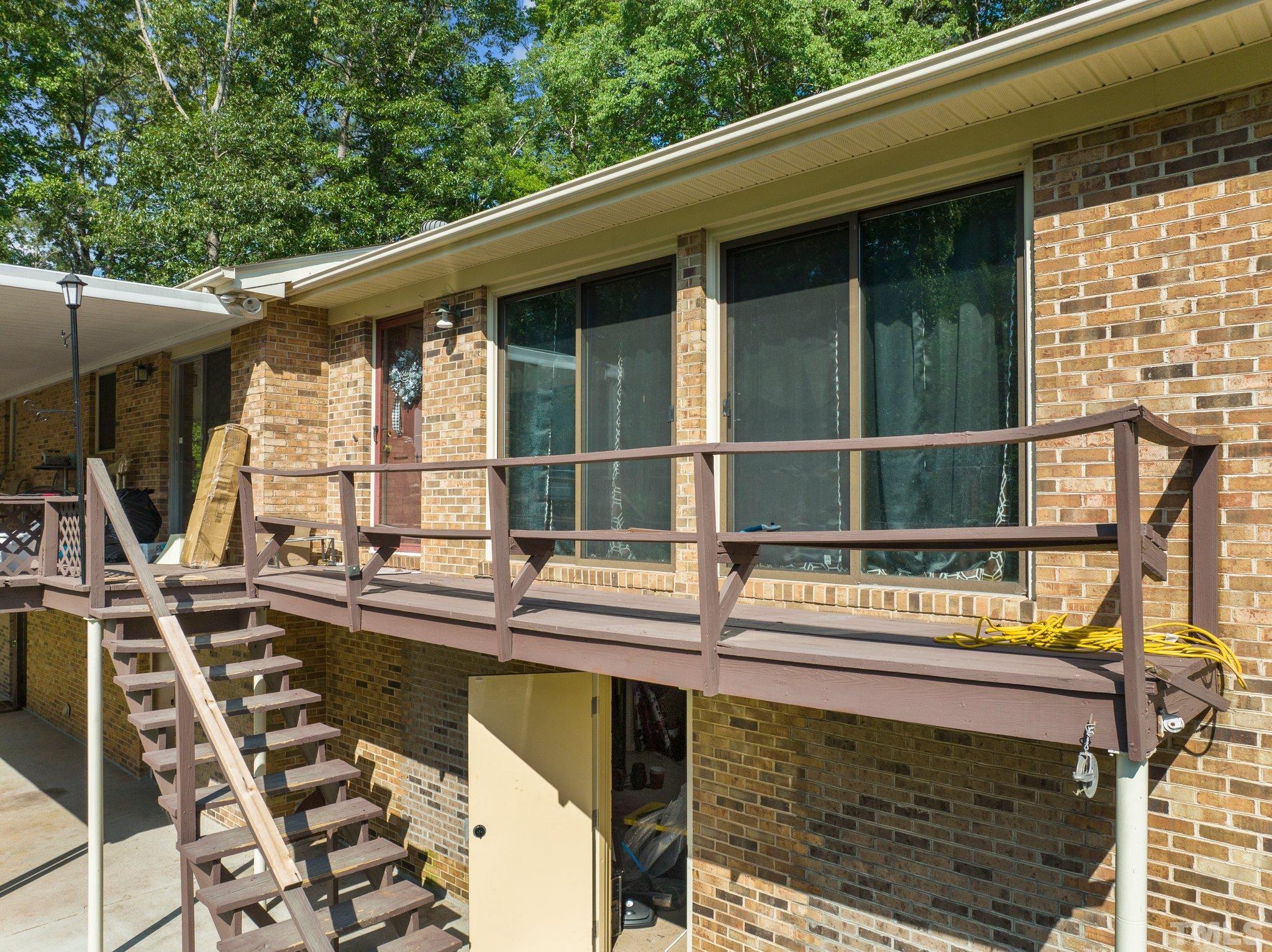 12233 Creedmoor Road Raleigh, NC 27613 - Photo 7 of 57 a balcony with a sink and wooden floor