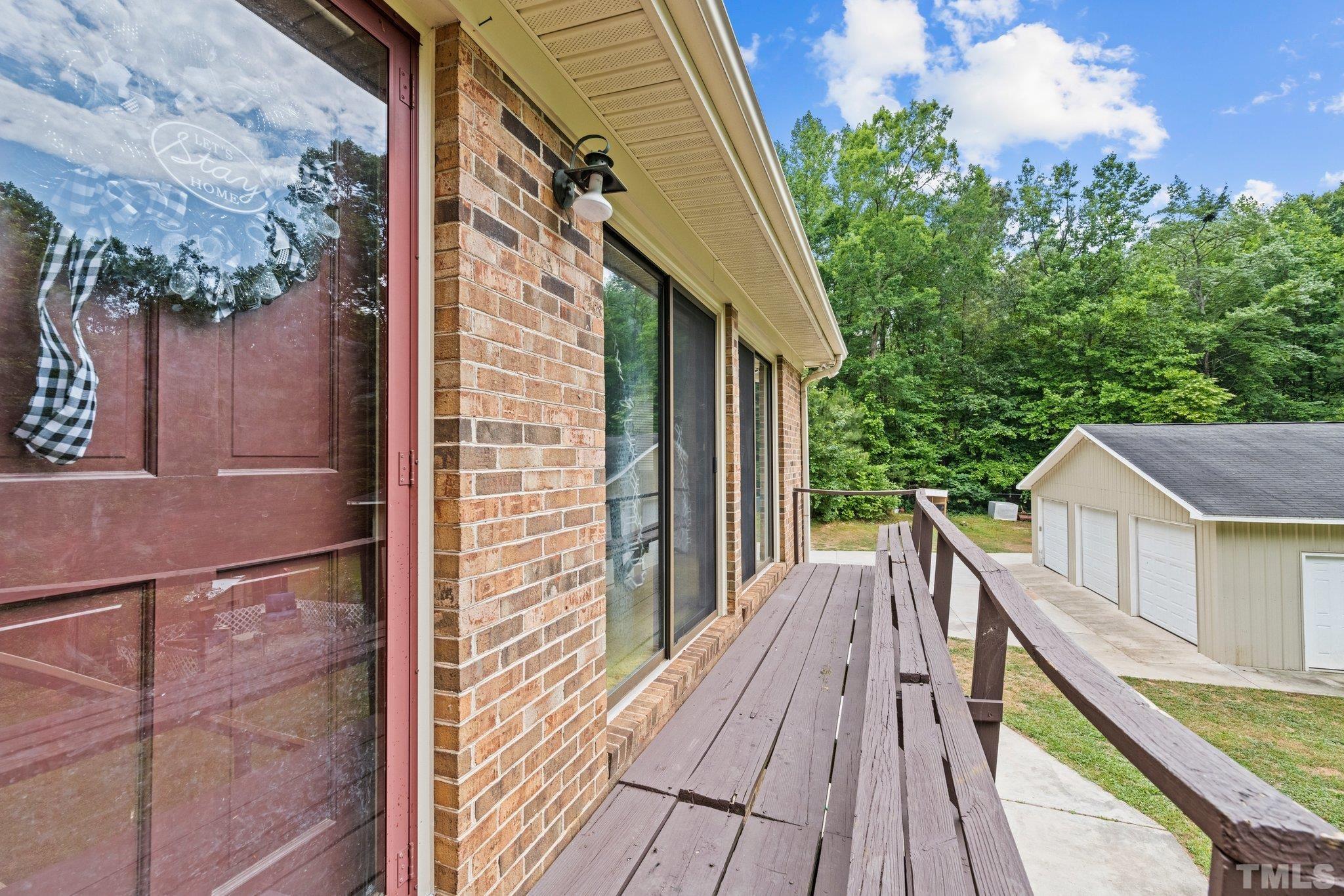 12233 Creedmoor Road Raleigh, NC 27613 - Photo 8 of 57 a view of balcony with wooden floor and fence