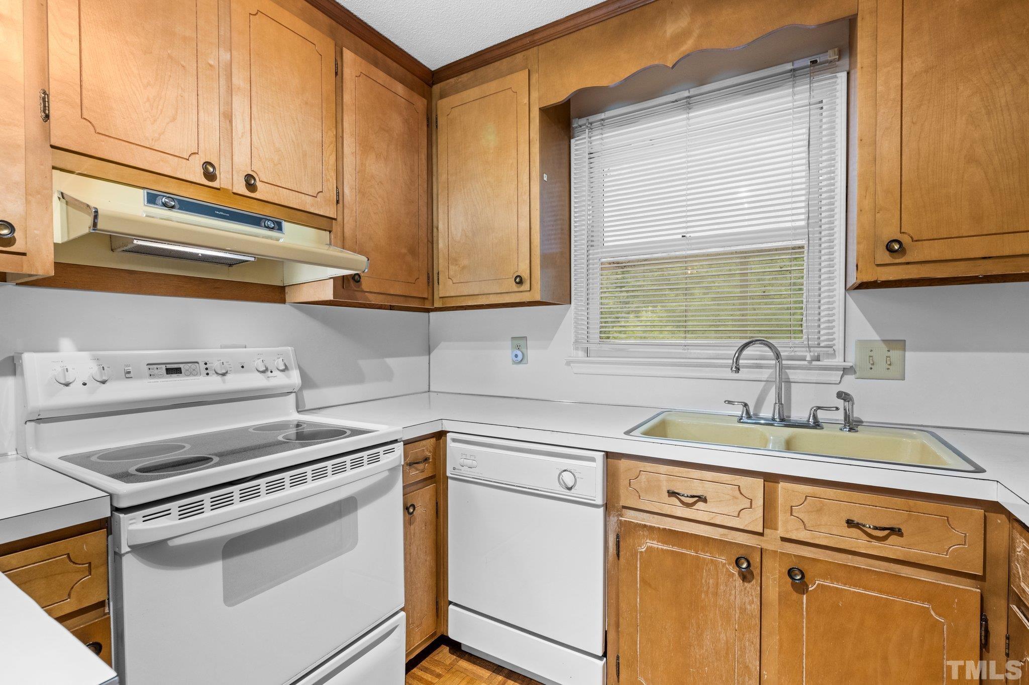 12233 Creedmoor Road Raleigh, NC 27613 - Photo 10 of 57 a kitchen with cabinets appliances a sink and a window