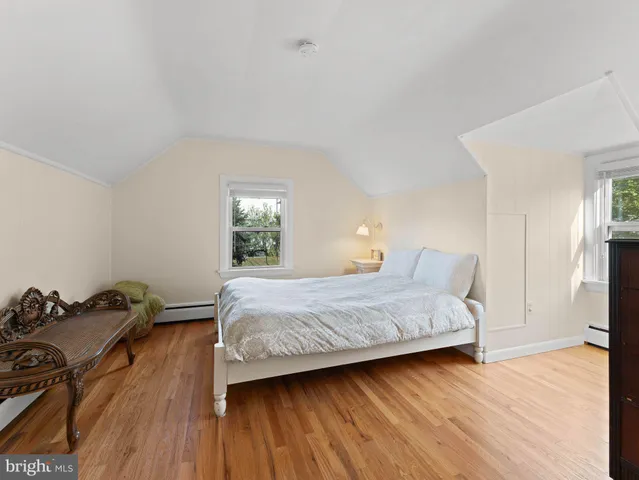 a bedroom with a bed and chair