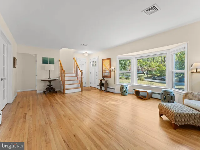 a view of a livingroom with furniture and a large window