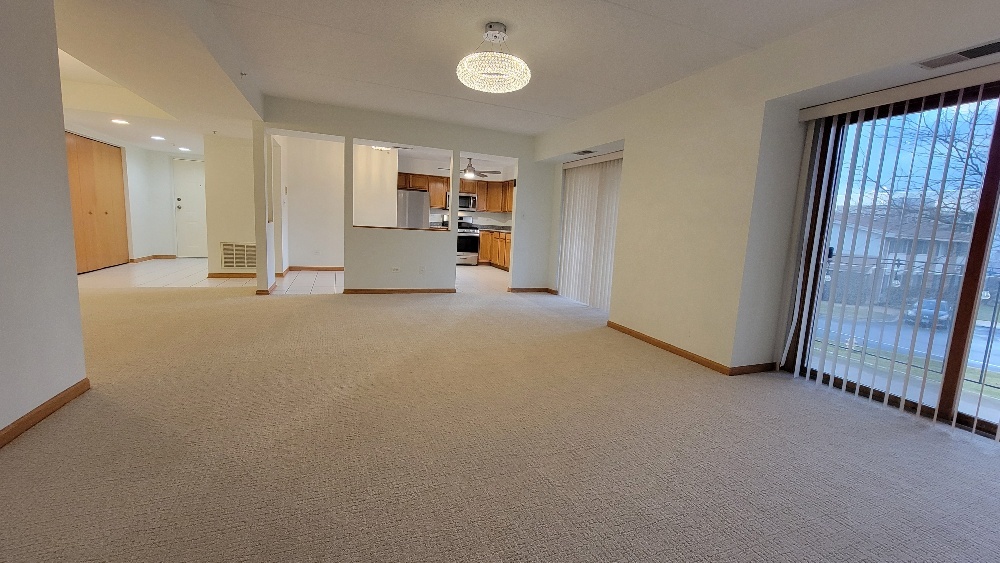 18100 Rita Road, Unit 2D Tinley Park, IL 60477 - Photo 13 of 28 a view of an empty room with a kitchen