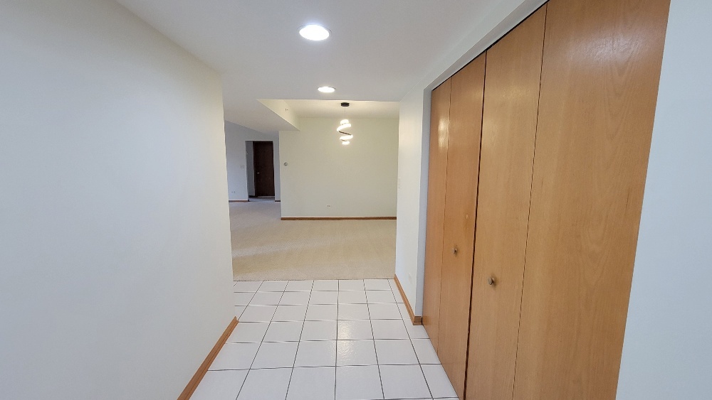 18100 Rita Road, Unit 2D Tinley Park, IL 60477 - Photo 14 of 28 a view of hallway with a window and a bathroom