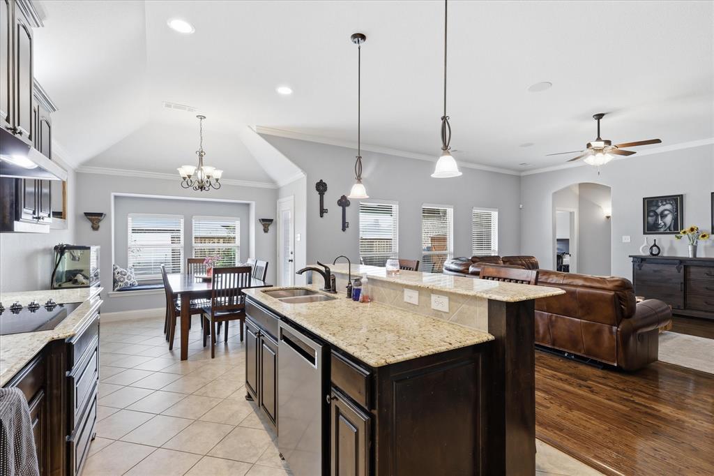 1105 Safrano Street Midlothian, TX 76065 - Photo 5 of 25 a view of a dining room and livingroom with furniture wooden floor a chandelier